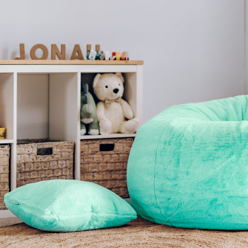 An elegant turquoise faux fur cushion, providing a plush and luxurious feel for ultimate comfort