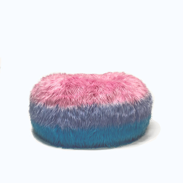 Lush rainbow tie-dye fur beanbag featuring vibrant shades of pink, purple, and turquoise, creating a playful and cozy seating option that adds a splash of color and texture to any room.
