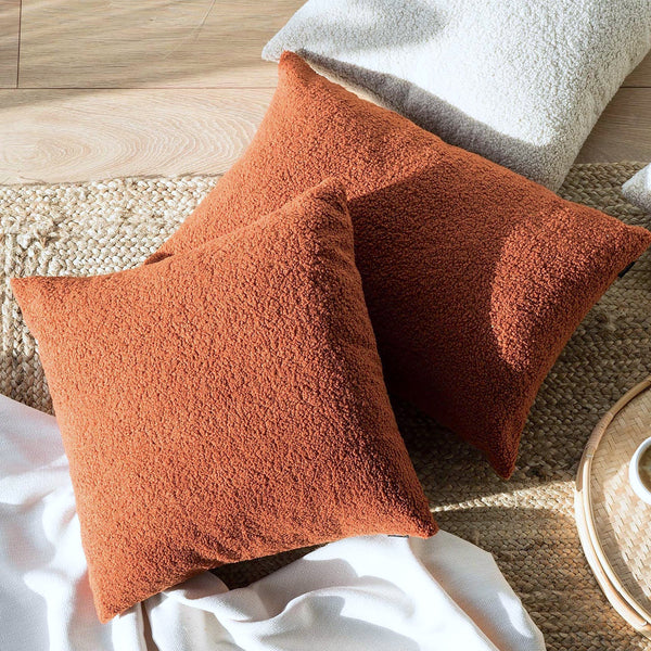 Rust Boucle Cushion: A warm and textured cushion featuring boucle fabric in a rich rust color, perfect for adding rustic elegance, warmth, and style to any seating or bedding arrangement.