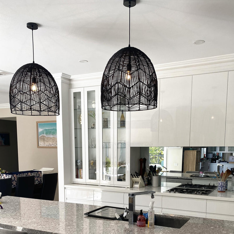 black rattan pendant light in a modern white kitchen with a stone bench top